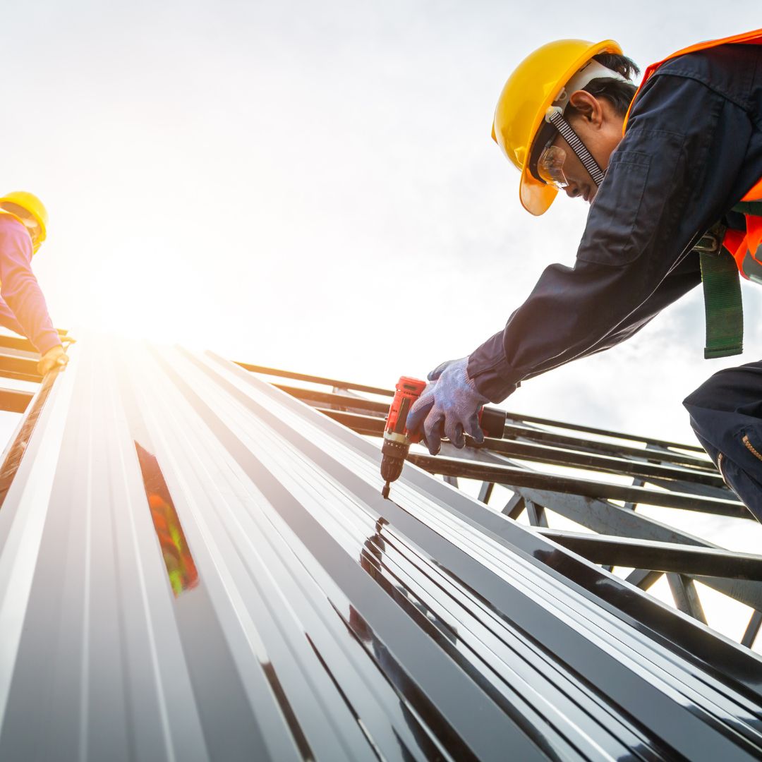 roofer installing metal roof
