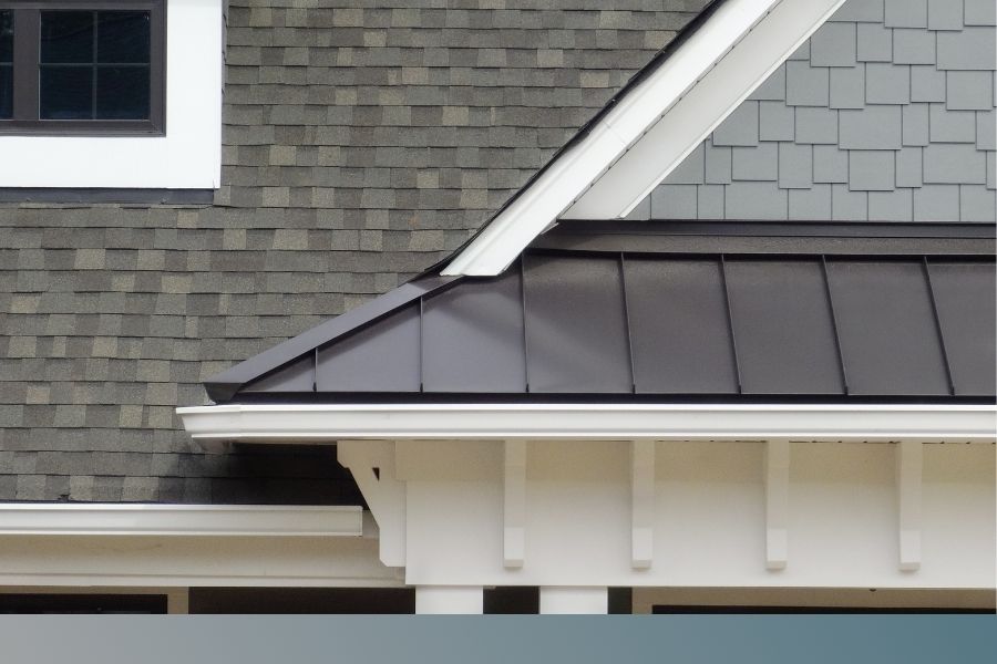 close up of house with shingle and metal roof
