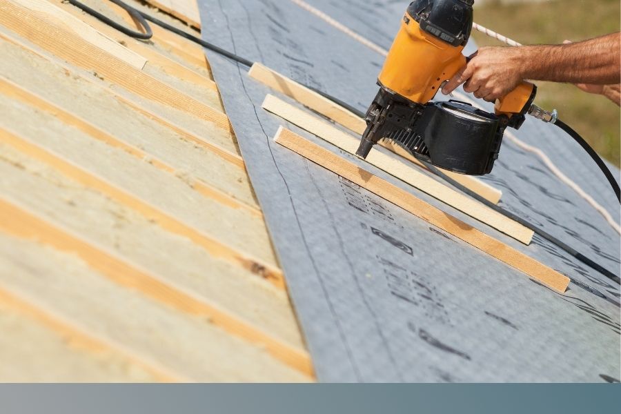 roofer secures decking for installation